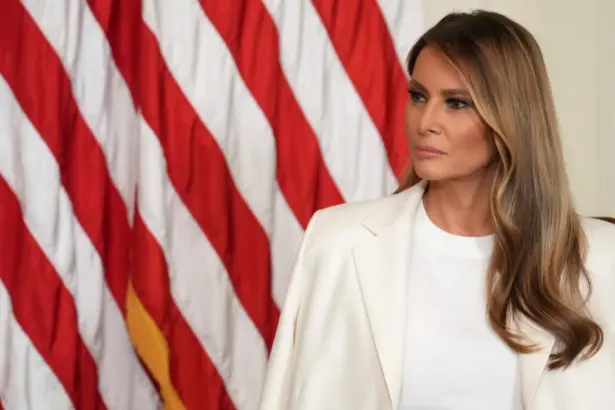 Portrait of Melania Trump in a formal dress, standing in the White House, symbolizing her role as First Lady.