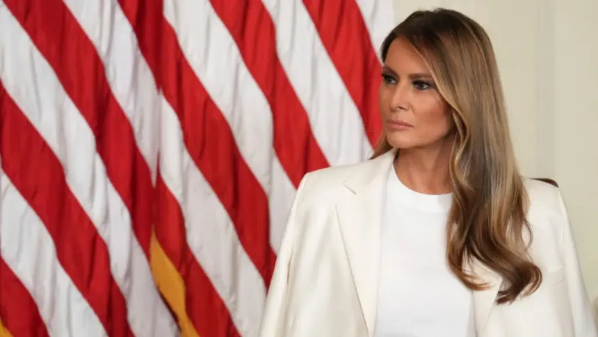 Portrait of Melania Trump in a formal dress, standing in the White House, symbolizing her role as First Lady.