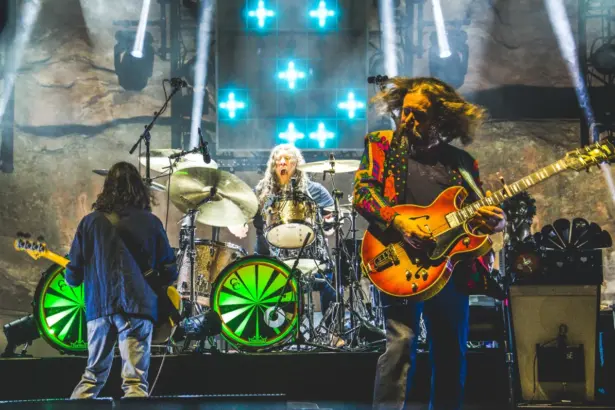 A vibrant collage featuring Thorn-Magazine Blog Band performing live, with colorful stage lighting, musical instruments, and a zine with bold text and artwork.